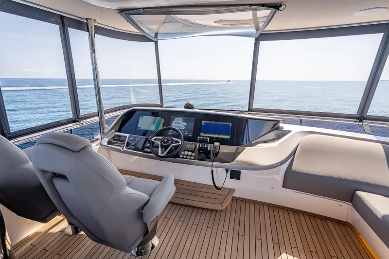 Iseablu Yacht Photos Pics Helm of 2023 Princess Y72 yacht with ocean view, featuring modern navigation equipment.