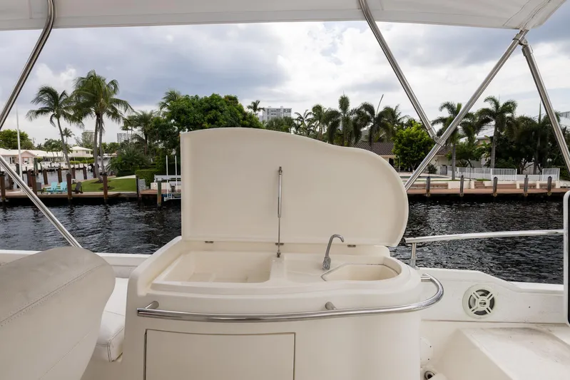 Sea Diva Yacht Photos Pics Azimut 58 yacht deck with sink, 1999 model, overlooking waterfront and palm trees.