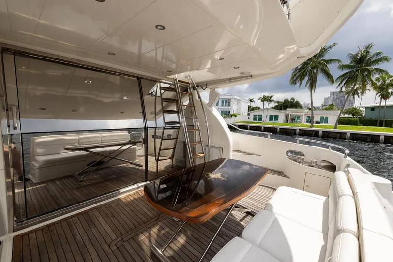 Sea Diva Yacht Photos Pics Luxurious 1999 Azimut 58 yacht deck with seating, table, and waterfront view.