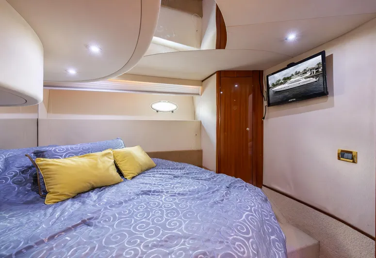 Sea Diva Yacht Photos Pics Luxurious bedroom interior of 1999 Azimut 58 yacht with cozy bedding and TV.