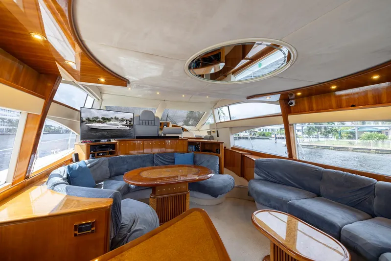 Sea Diva Yacht Photos Pics Luxurious interior of a 1999 Azimut 58 yacht with plush seating and elegant wood finishes.