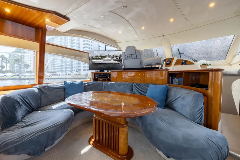Sea Diva Yacht Photos Pics Luxurious interior of a 1999 Azimut 58 yacht with plush seating and elegant wood finishes.