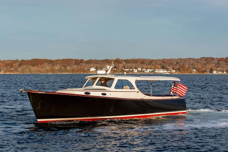 Drowsy Maggie Yacht Photos Pics 2000 Hinckley Picnic Boat Classic cruising on a scenic lake with autumn foliage.