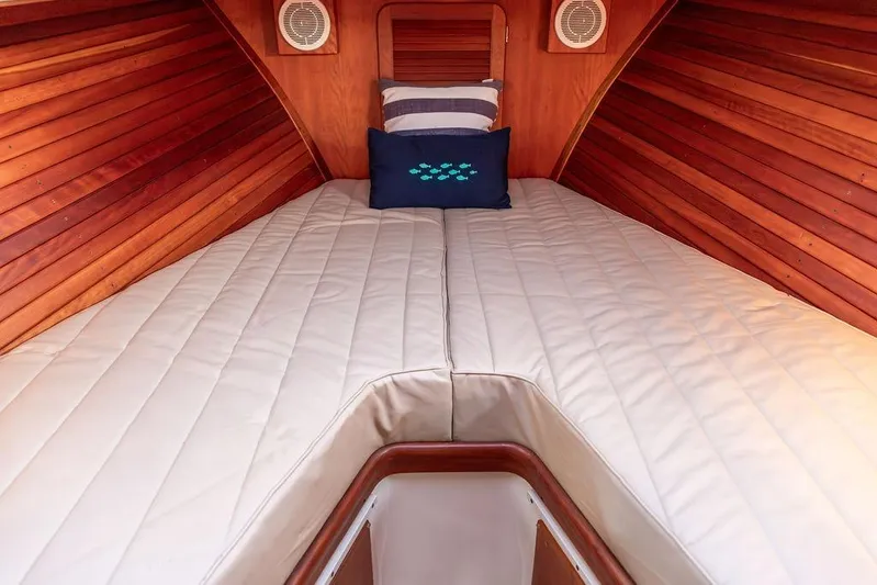 Drowsy Maggie Yacht Photos Pics Interior of 2001 Hinckley Ya Picn boat with cozy wooden cabin and cushioned bed.