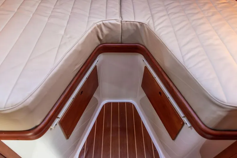 Drowsy Maggie Yacht Photos Pics Interior of 2001 Hinckley Ya Picn boat with wooden accents and cushioned seating.