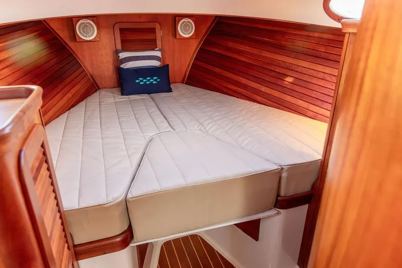 Drowsy Maggie Yacht Photos Pics Luxurious cabin interior of 2001 Hinckley Ya Picn boat with wooden paneling.