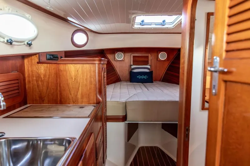 Drowsy Maggie Yacht Photos Pics Interior of 2001 Hinckley Ya Picn boat with wooden cabinetry and cozy sleeping area.