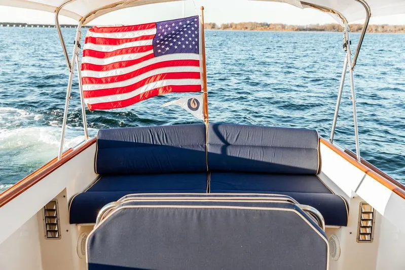 Drowsy Maggie Yacht Photos Pics Hinckley Ya Picn 2001 boat with American flag on open water.