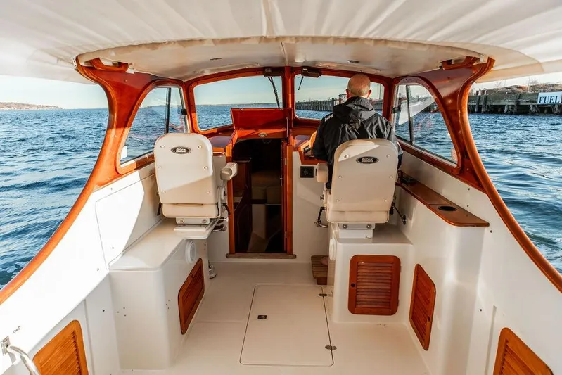 Drowsy Maggie Yacht Photos Pics 2001 Hinckley Ya Picn boat interior with captain navigating on open water.