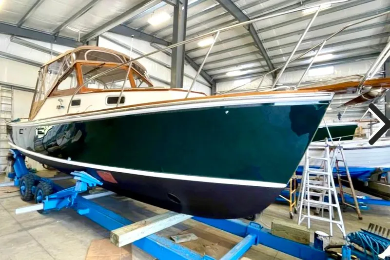 Dulce Yacht Photos Pics 2003 Dyer 29 Soft Top boat in a storage facility on a blue trailer.