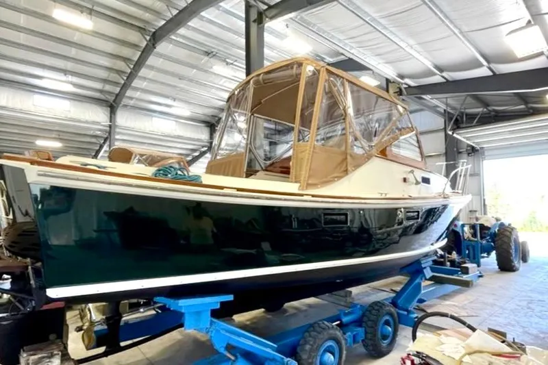Dulce Yacht Photos Pics 2003 Dyer 29 Soft Top boat in a storage facility on a blue trailer.