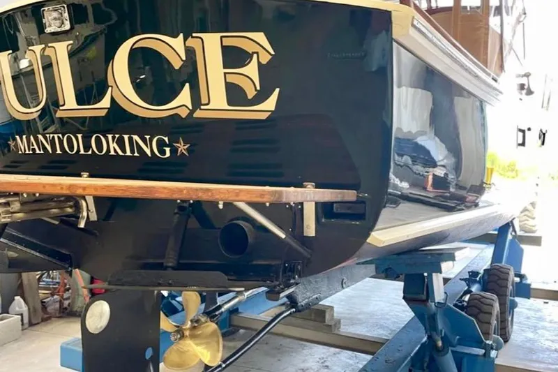 Dulce Yacht Photos Pics 2003 Dyer 29 Soft Top boat on lift, showcasing propeller and hull details.