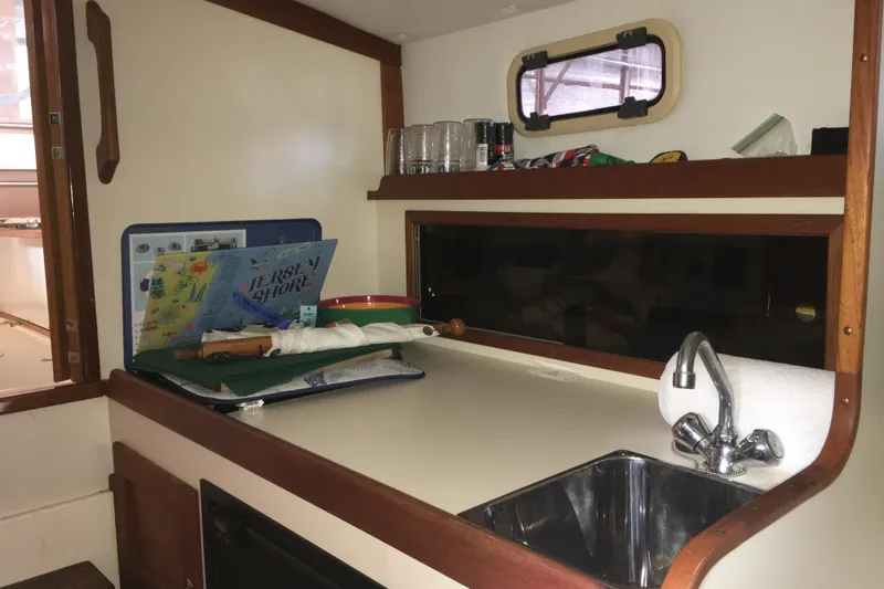 Dulce Yacht Photos Pics 2003 Dyer 29 Soft Top boat interior with sink and countertop accessories.