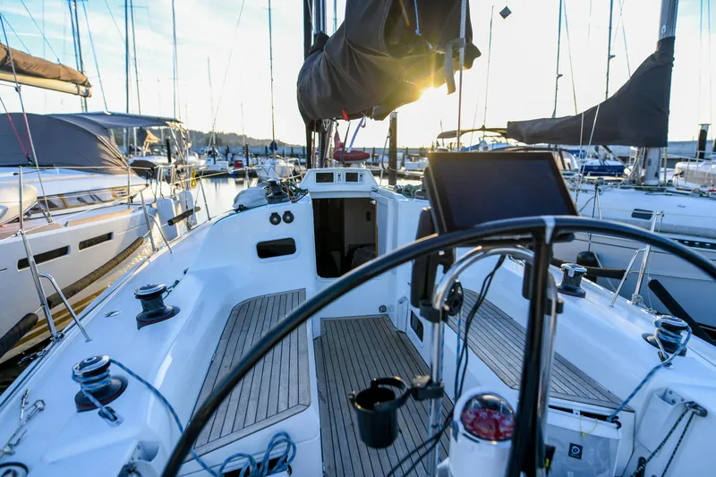 "mah Na Mah Na" Yacht Photos Pics 2020 J Boats J/112E sailboat cockpit with steering wheel, docked at marina during sunset.