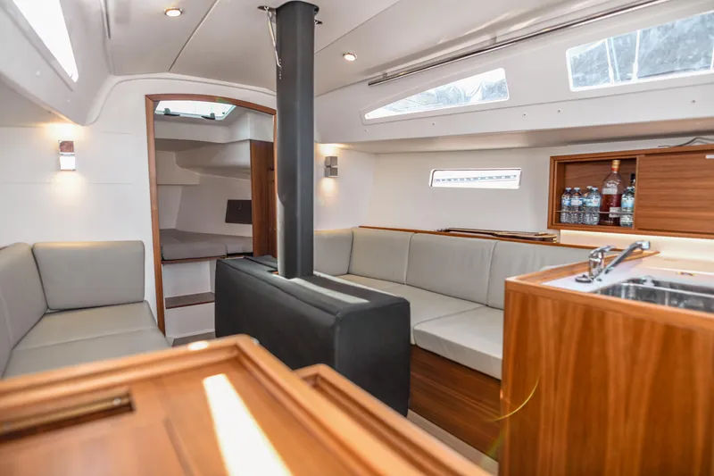 "mah Na Mah Na" Yacht Photos Pics 2020 J Boats J/112E yacht interior with modern seating, wood finishes, and kitchenette.