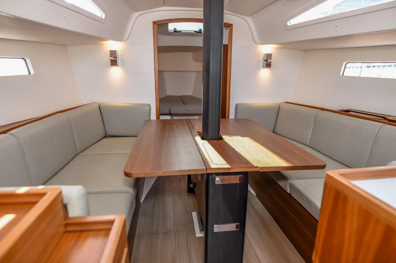 "mah Na Mah Na" Yacht Photos Pics Interior of 2020 J Boats J/112E sailboat with modern seating and wooden table.