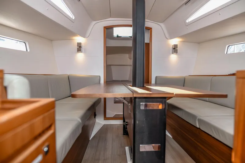 "mah Na Mah Na" Yacht Photos Pics Interior of 2020 J Boats J/112E sailboat, featuring modern seating and wooden table.