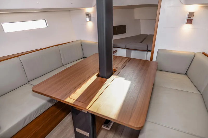 "mah Na Mah Na" Yacht Photos Pics Interior of 2020 J Boats J/112E sailboat with wooden table and cushioned seating.