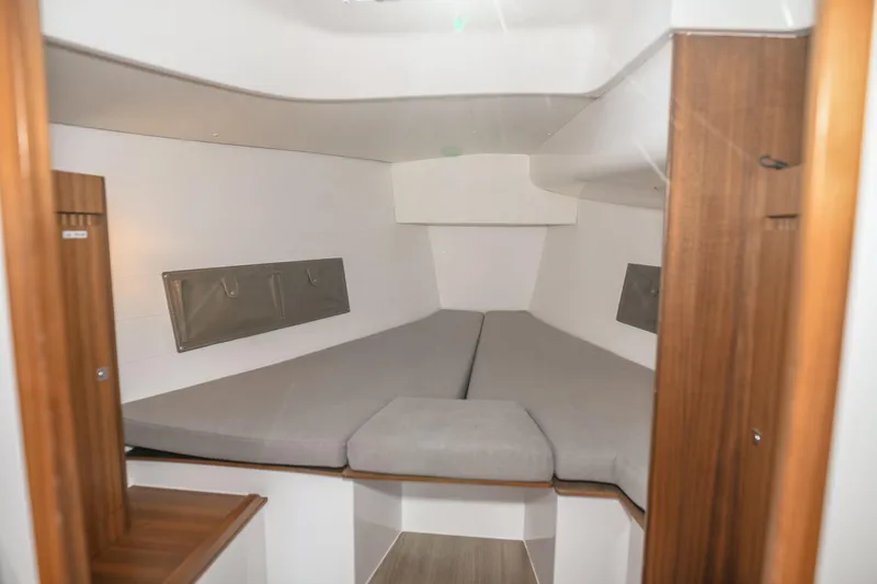 "mah Na Mah Na" Yacht Photos Pics 2020 J Boats J/112E interior cabin with cozy gray bedding and wooden accents.