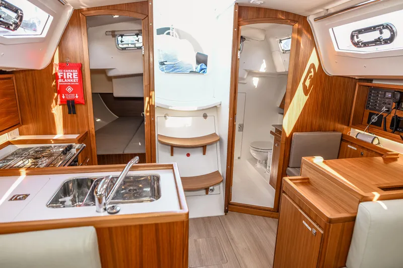 "mah Na Mah Na" Yacht Photos Pics Interior of 2020 J Boats J/112E sailboat with wood finish, kitchen, and bathroom.