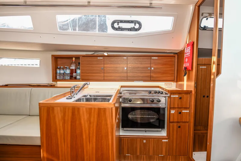 "mah Na Mah Na" Yacht Photos Pics 2020 J Boats J/112E yacht interior with modern kitchen, wooden cabinetry, and appliances.