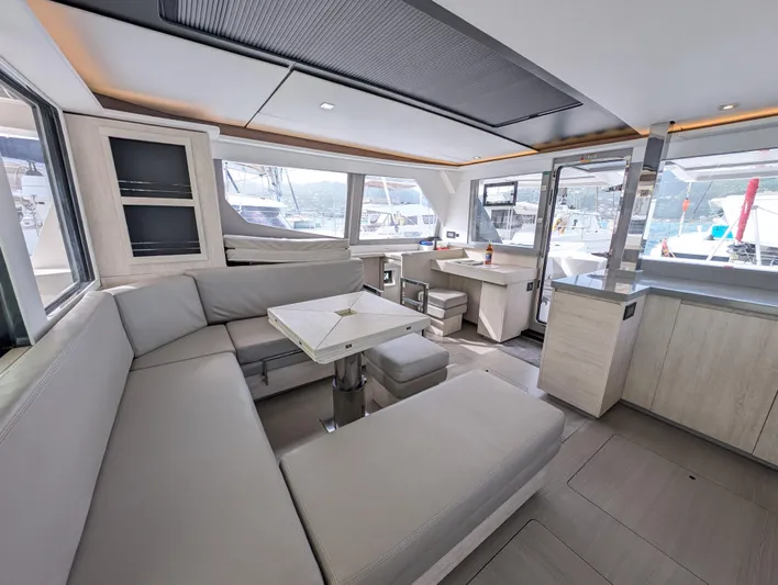Salty Kiss Yacht Photos Pics Luxurious interior of a 2020 Leopard 45 yacht with modern seating and panoramic windows.
