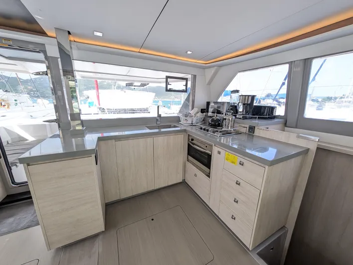 Salty Kiss Yacht Photos Pics Modern kitchen interior on a 2020 Leopard 45 yacht, featuring sleek countertops and appliances.