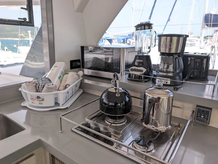 Salty Kiss Yacht Photos Pics Modern kitchen in 2020 Leopard 45 yacht with appliances and ocean view.