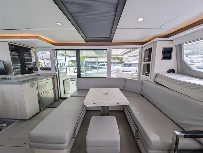 Salty Kiss Yacht Photos Pics Luxurious interior of 2020 Leopard 45 yacht with modern seating and panoramic windows.