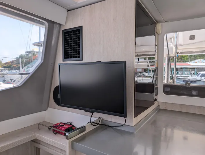 Salty Kiss Yacht Photos Pics Interior of a 2020 Leopard 45 yacht featuring a mounted TV and modern design elements.