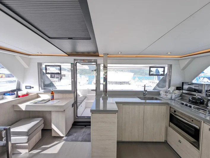 Salty Kiss Yacht Photos Pics Modern interior of 2020 Leopard 45 yacht with kitchen and dining area.