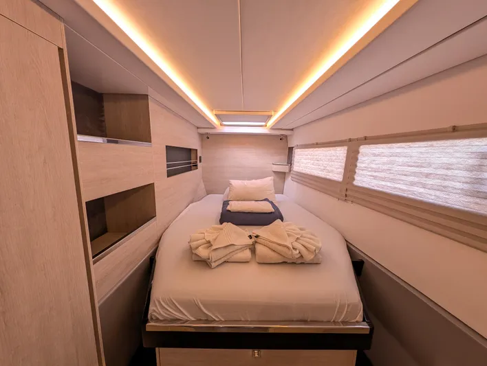 Salty Kiss Yacht Photos Pics Luxurious cabin interior of 2020 Leopard 45 yacht with cozy bed and ambient lighting.