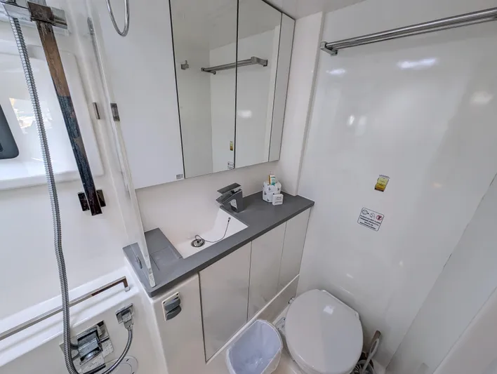 Salty Kiss Yacht Photos Pics Modern bathroom in 2020 Leopard 45 yacht with sleek fixtures and mirrored cabinets.