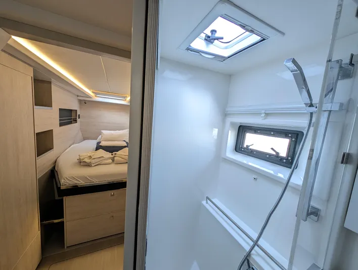 Salty Kiss Yacht Photos Pics Luxurious interior of 2020 Leopard 45 yacht featuring bedroom and bathroom.