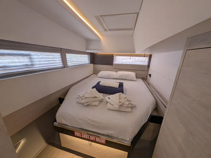 Salty Kiss Yacht Photos Pics Luxurious cabin interior of a 2020 Leopard 45 yacht with a neatly made bed.