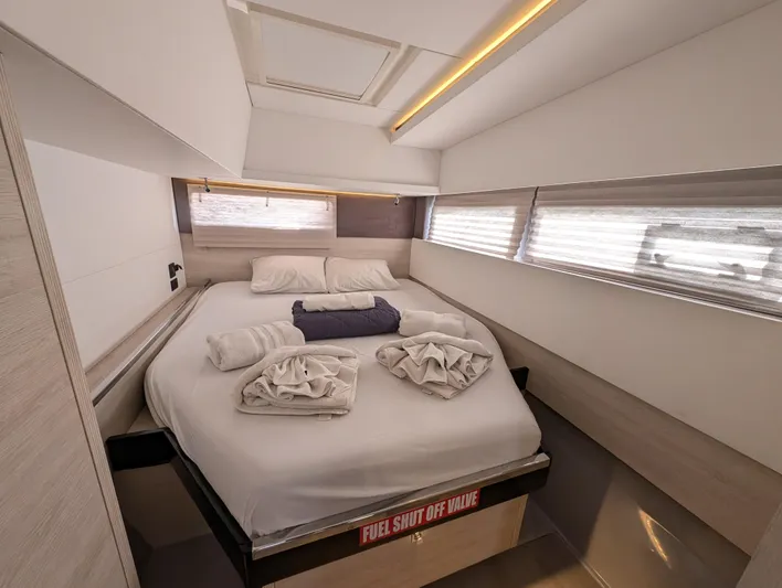 Salty Kiss Yacht Photos Pics Luxurious cabin interior of 2020 Leopard 45 yacht with neatly arranged bed linens.
