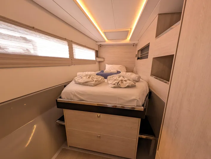 Salty Kiss Yacht Photos Pics Luxurious cabin interior of a 2020 Leopard 45 yacht with cozy bedding and ambient lighting.