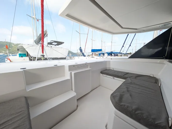 Salty Kiss Yacht Photos Pics Leopard 45 catamaran cockpit with cushioned seating, docked at marina, 2020 model.