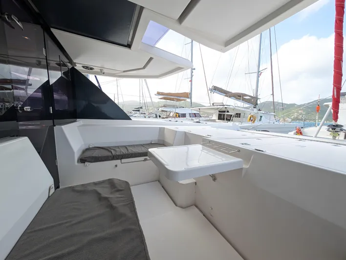 Salty Kiss Yacht Photos Pics Leopard 45 yacht interior, 2020 model, featuring a sleek seating area and table.