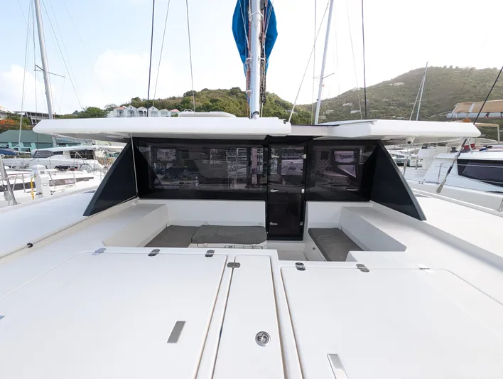 Salty Kiss Yacht Photos Pics 2020 Leopard 45 catamaran deck with seating area and modern design.