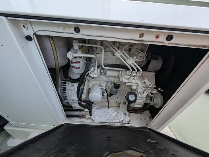 Salty Kiss Yacht Photos Pics Engine compartment of a 2020 Leopard 45 yacht, showcasing mechanical components and wiring.