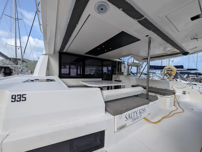 Salty Kiss Yacht Photos Pics 2020 Leopard 45 yacht with outdoor seating, docked at marina.