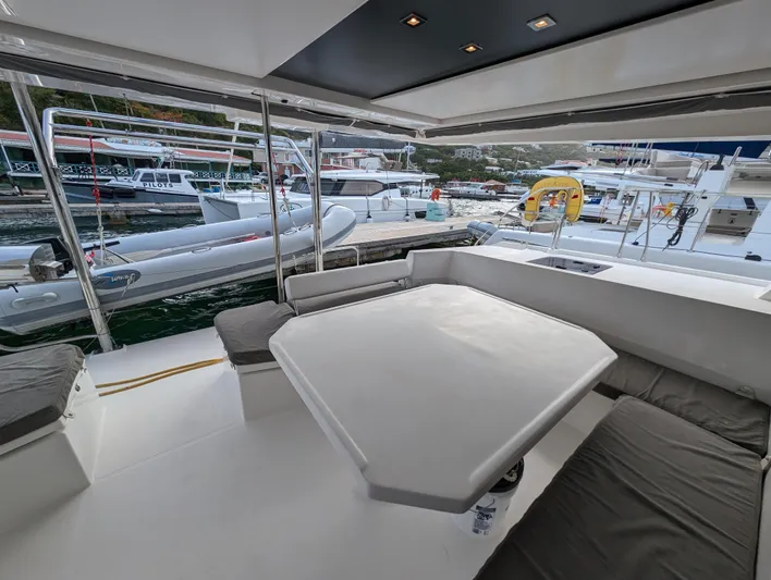 Salty Kiss Yacht Photos Pics Leopard 45 yacht interior, 2020 model, docked with surrounding boats in marina.