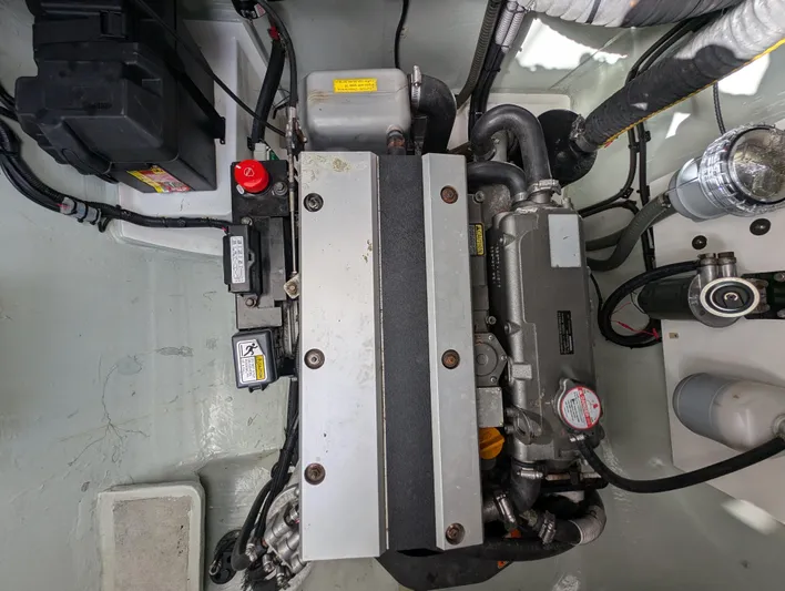 Salty Kiss Yacht Photos Pics Engine compartment of a 2020 Leopard 45 catamaran, showcasing mechanical components and wiring.