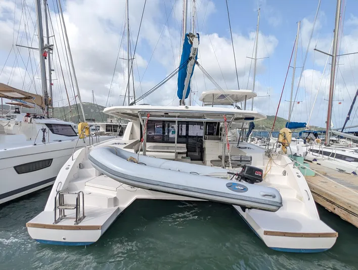 Salty Kiss Yacht Photos Pics 2020 Leopard 45 catamaran docked with inflatable boat on stern.