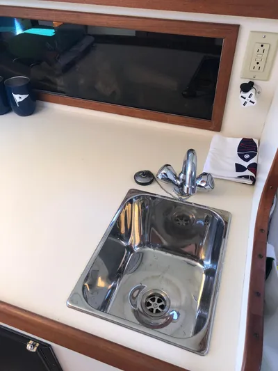 Dulce Yacht Photos Pics 2003 Dyer 29 Soft Top boat interior with stainless steel sink and faucet.