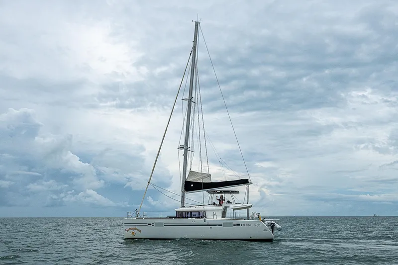 Somewhere Yacht Photos Pics 2018 Lagoon 450 catamaran sailing on a cloudy sea.