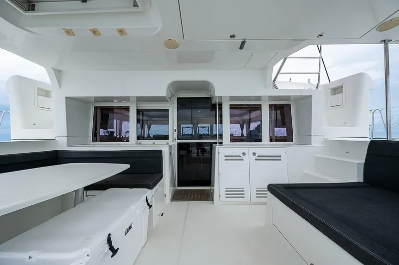 Somewhere Yacht Photos Pics Spacious interior of 2018 Lagoon 450 catamaran with modern seating and sleek design.