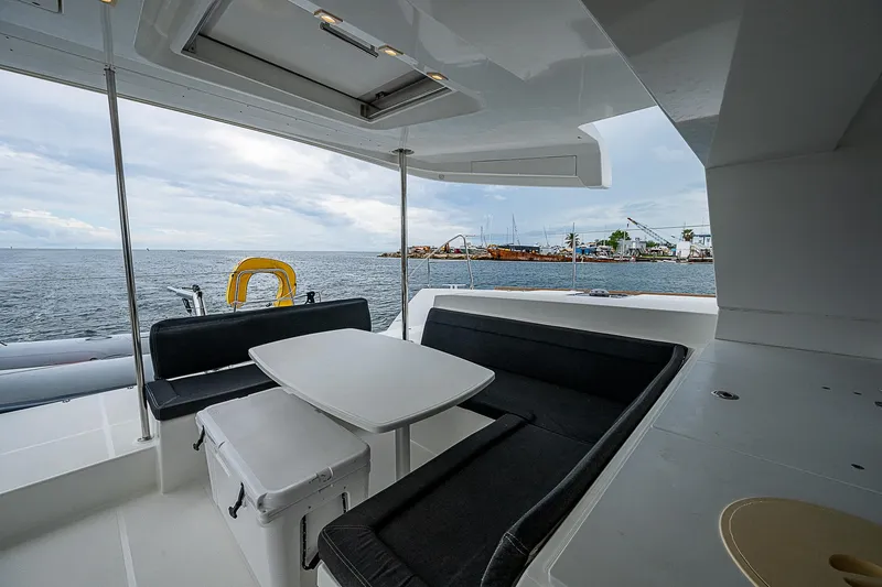 Somewhere Yacht Photos Pics 2018 Lagoon 450 yacht interior with seating area and ocean view.