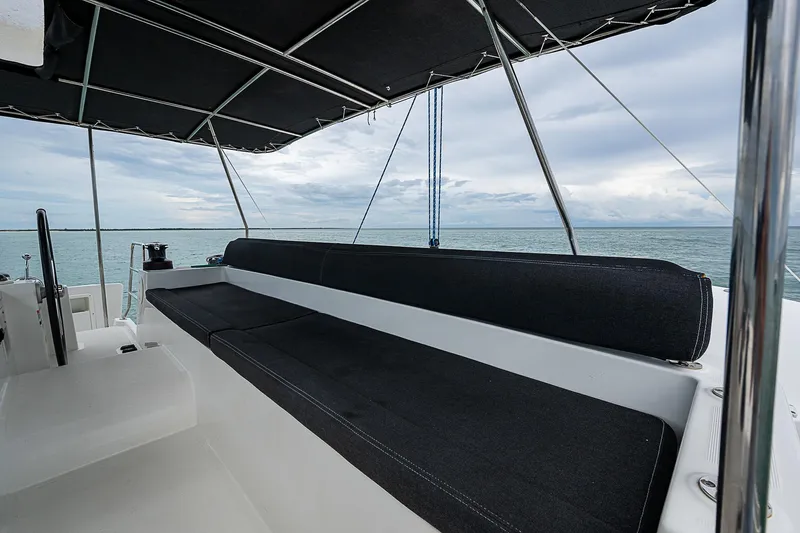 Somewhere Yacht Photos Pics 2018 Lagoon 450 yacht deck with black seating and ocean view.